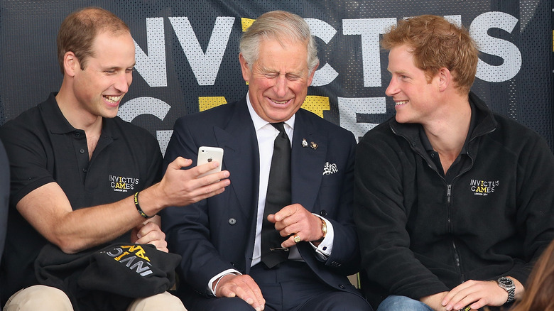 Prince Charles, Harry, and William smiling together