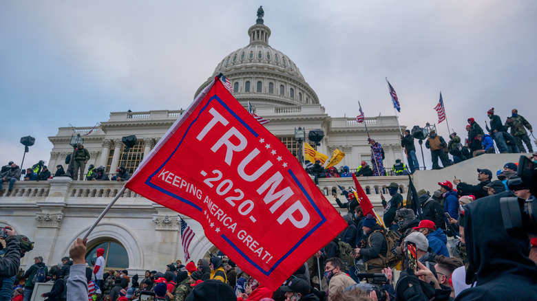 January 6 insurrection with supporters carrying flags