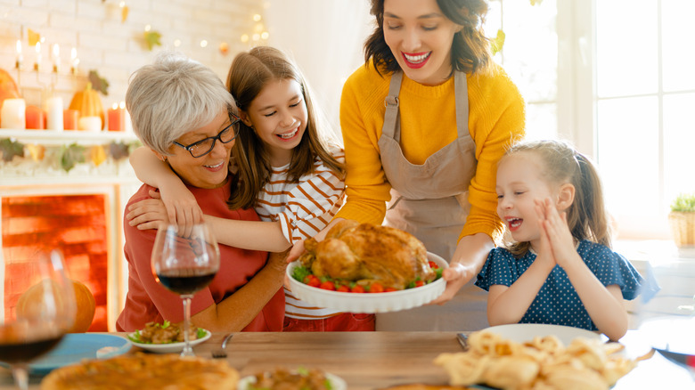 A family preparing to eat on Thanksgiving