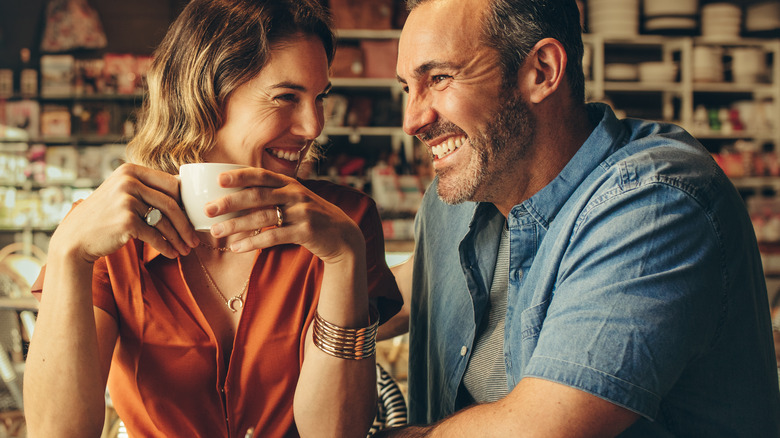 Couple having coffee and smiling