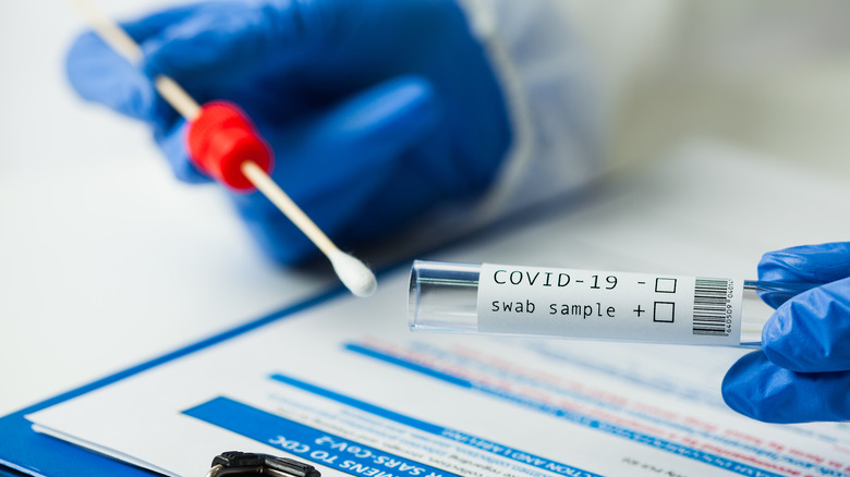 Worker taking swab tests for COVID-19