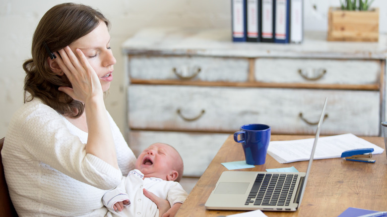 Mom working while caring for baby