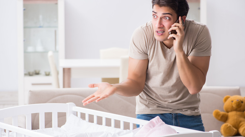 Dad calling for help with baby