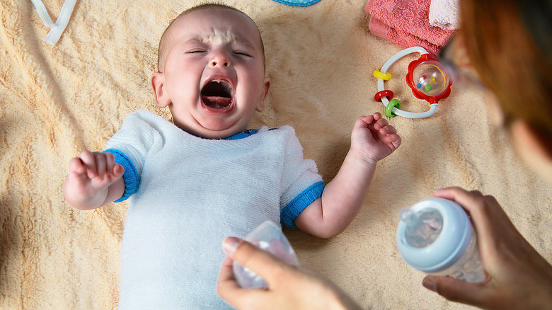 parent attempting to soothe baby