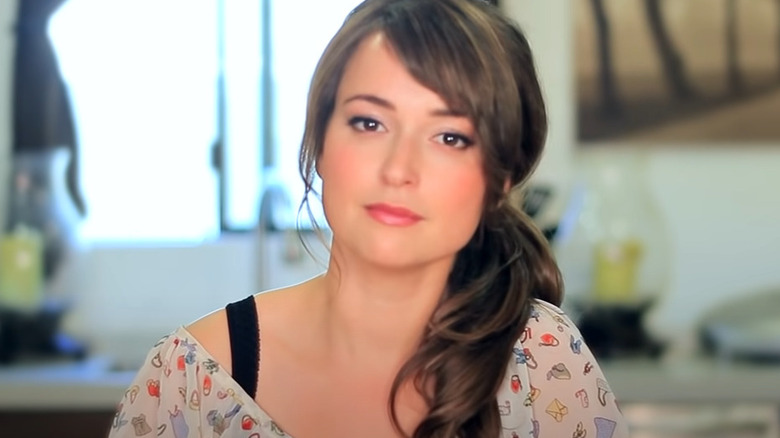 Milana Vayntrub smiling painfully