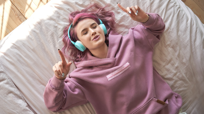 Woman lying on bed and singing