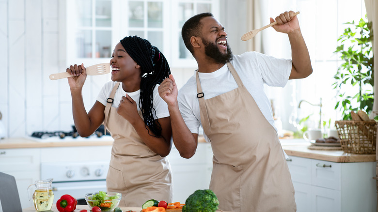 Couple singing together in kitchen