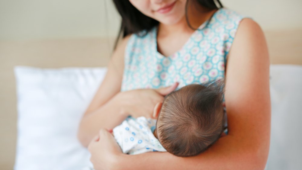 woman nursing baby