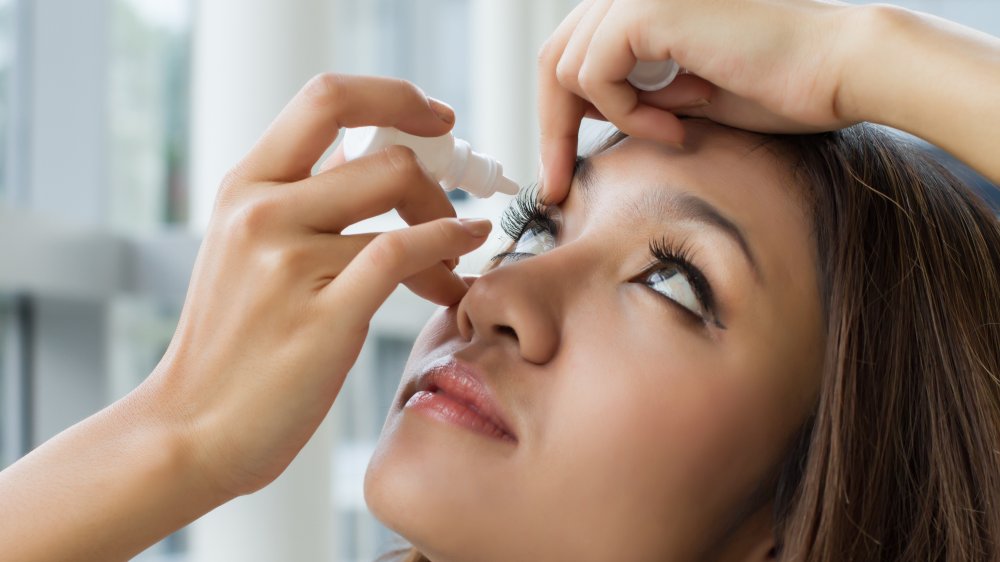 Woman using eye drops