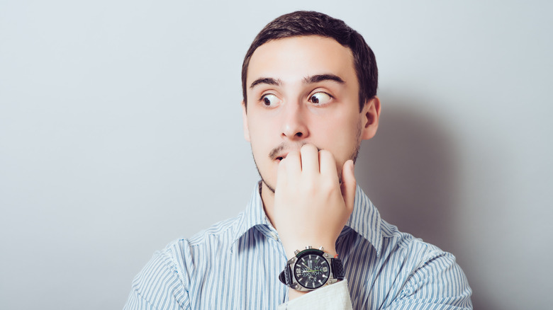 Man biting nails