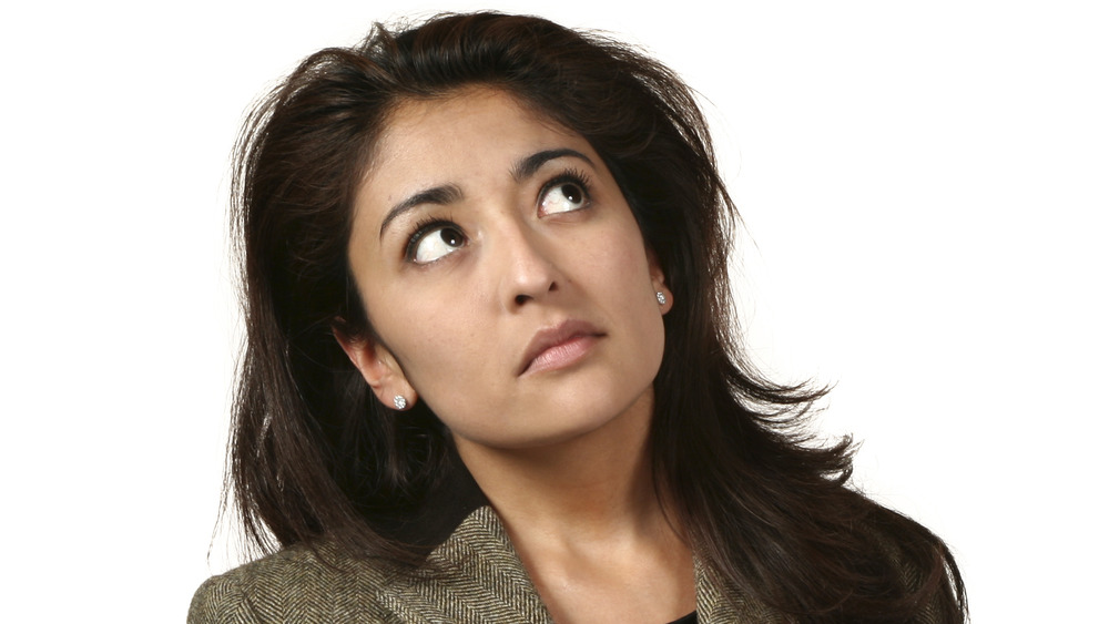 Woman in business suit pondering