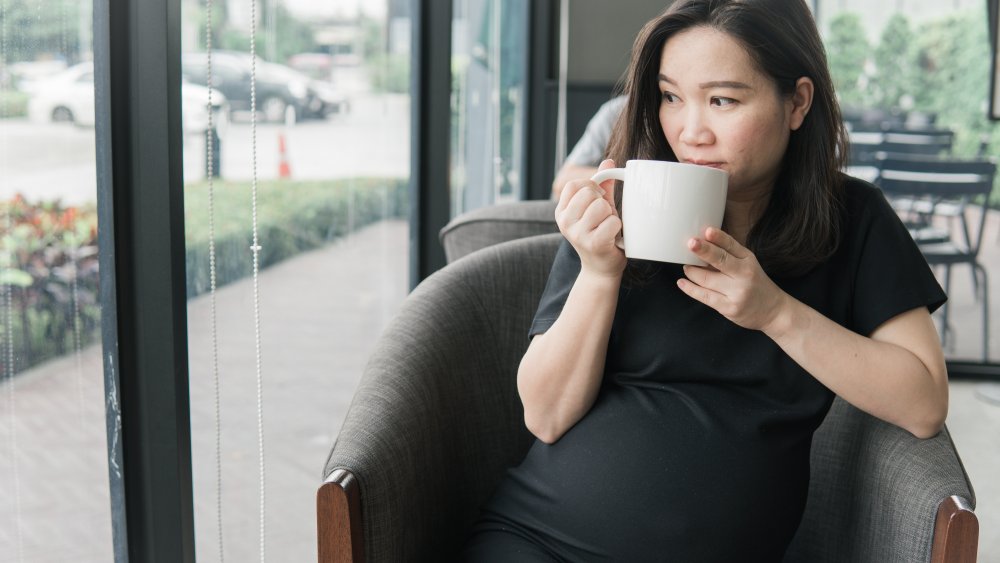 Pregnant woman drinking coffee