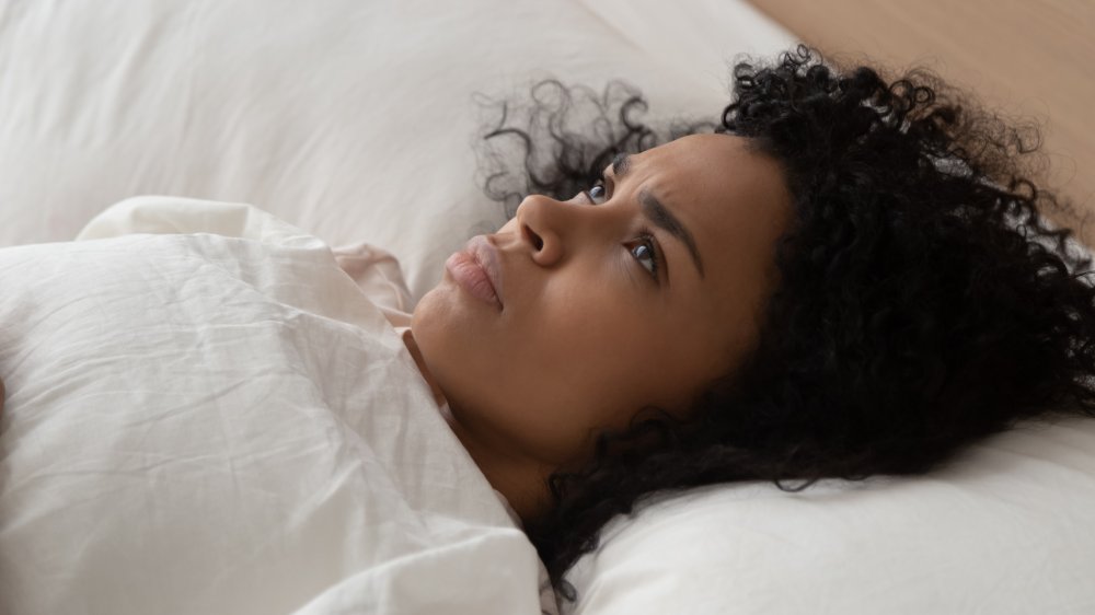 Woman lying awake in bed