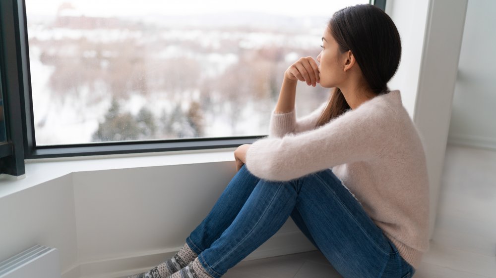 Stressed woman on cloudy day