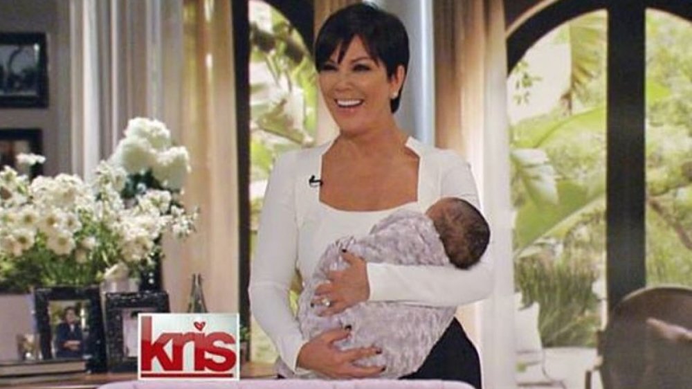 Kris Jenner holding a baby on her canceled celebrity talk show