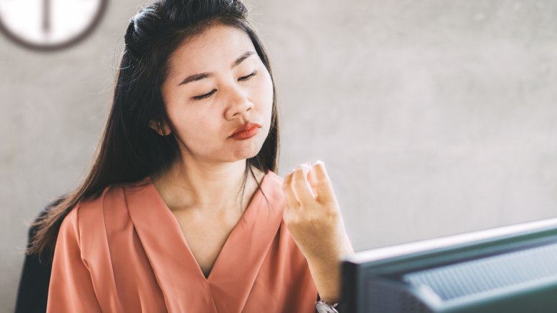 Woman procrastinating at office