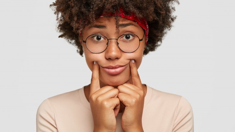 woman forcing herself to smile