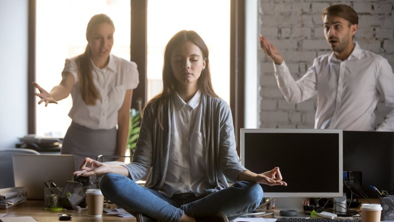 woman meditating in office