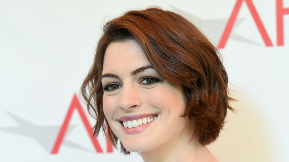 Anne Hathaway smiles on red carpet