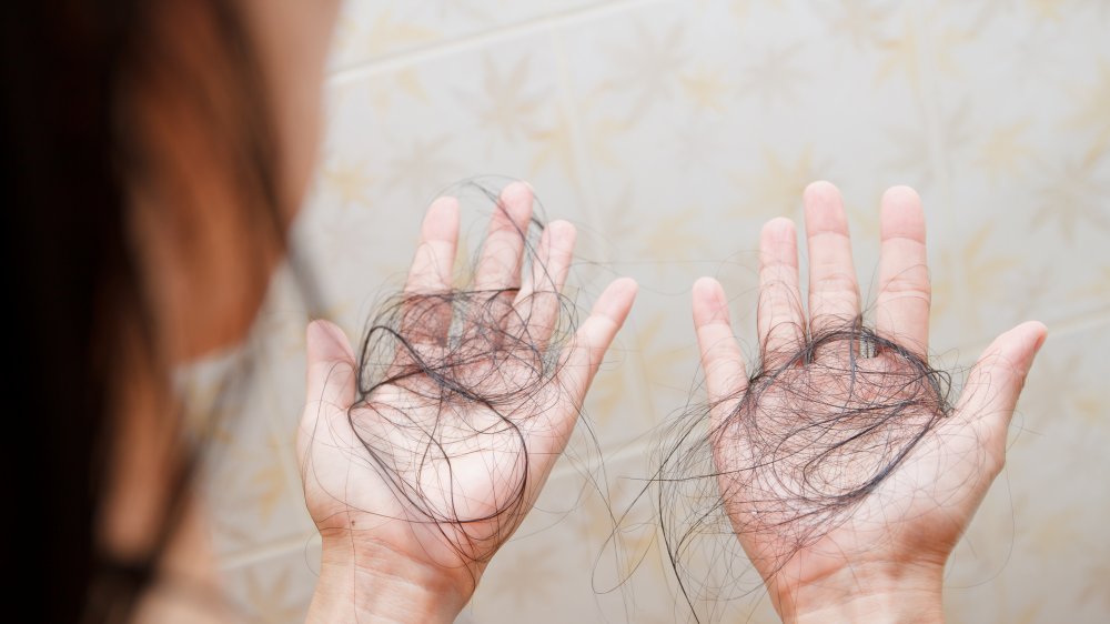 Woman in the shower with failling hair