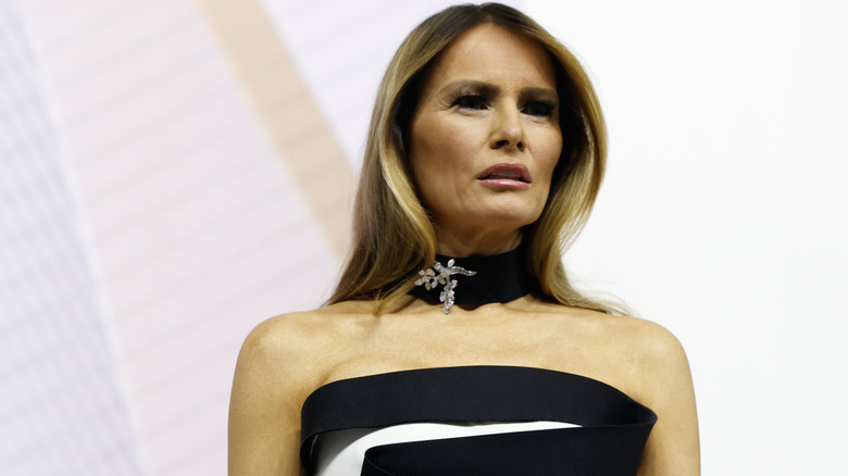 Melania Trump scowling while wearing an evening gown