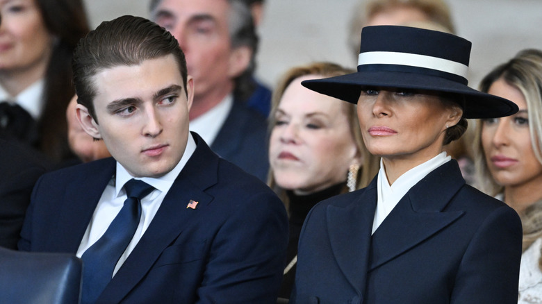 Barron Trump and Melania Trump sitting net to each other