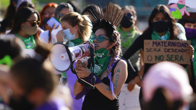 woman protesting wearing green