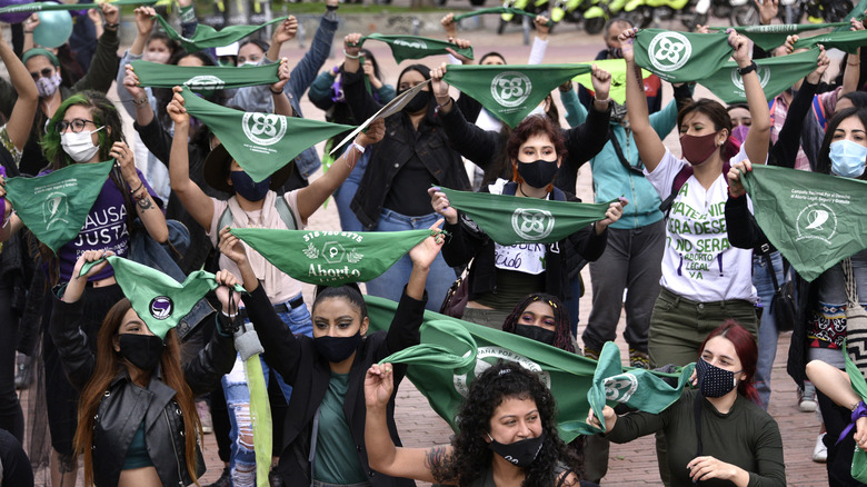 Protestors in Colombia carrying green bandanas