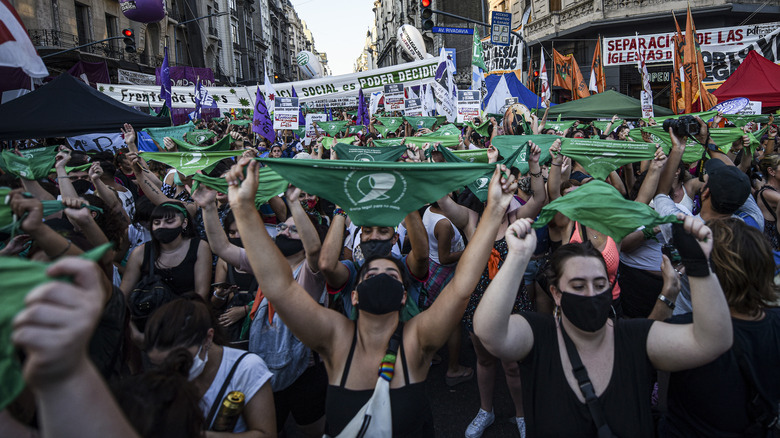 Abortion advocates marching, wearing green