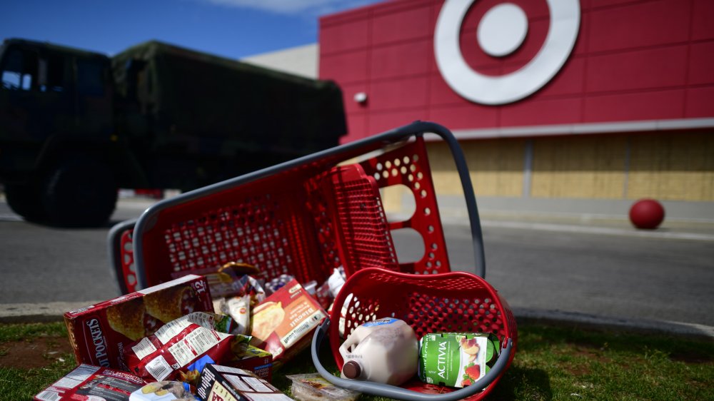 Boarded up Target with groceries on the ground