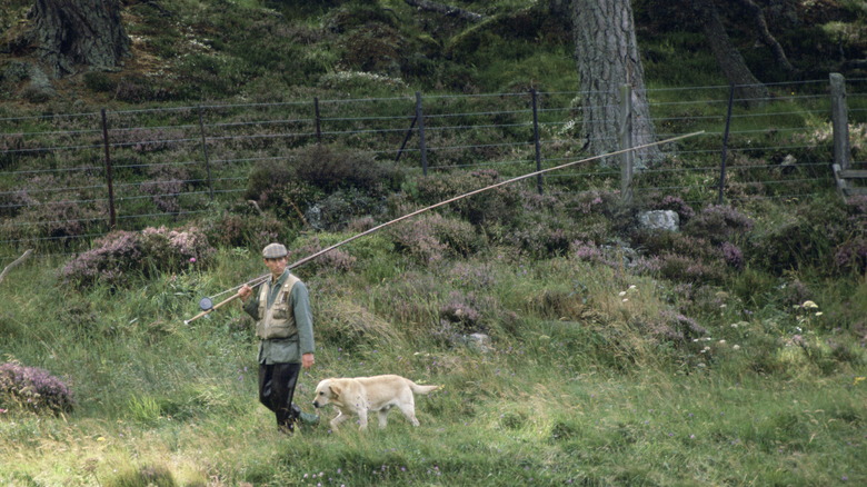 Prince Charles walking with his dog 