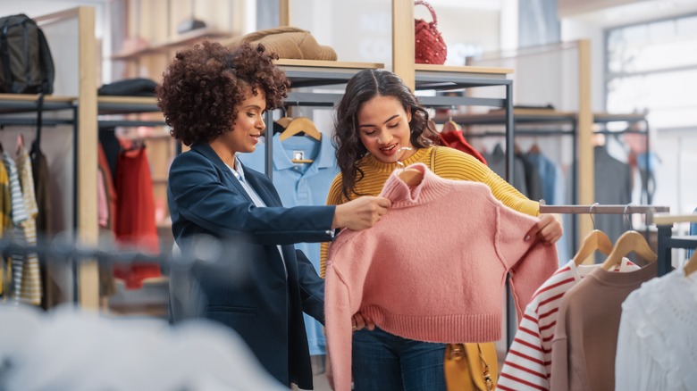 Woman looking at sweater 