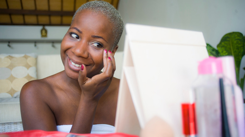 Woman applying makeup with her fingers