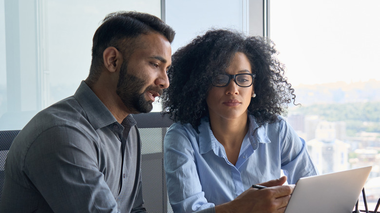 Man and woman looking at computer 