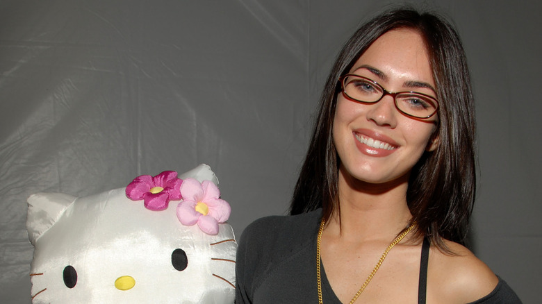 megan fox with glasses smiling with hello kitty