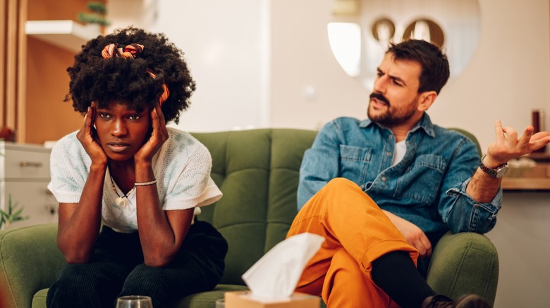 Man arguing with woman on couch