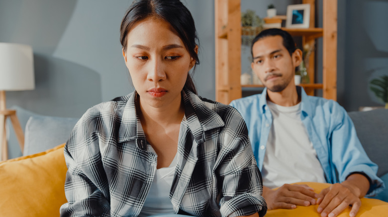 Man staring at upset woman