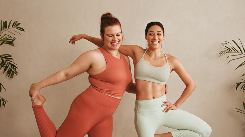 Happy women in workout clothes