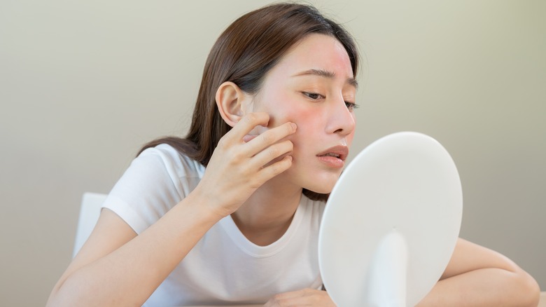 Woman looking at red skin