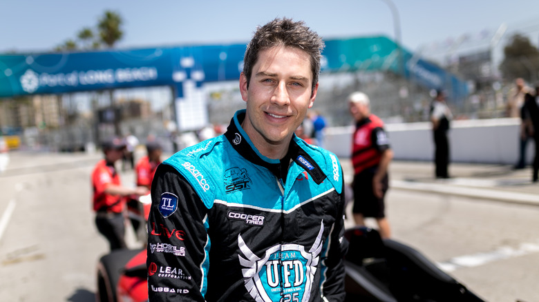 Arie Luyendyk, Jr posing with car 