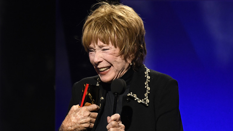 Shirley MacLaine laughing onstage