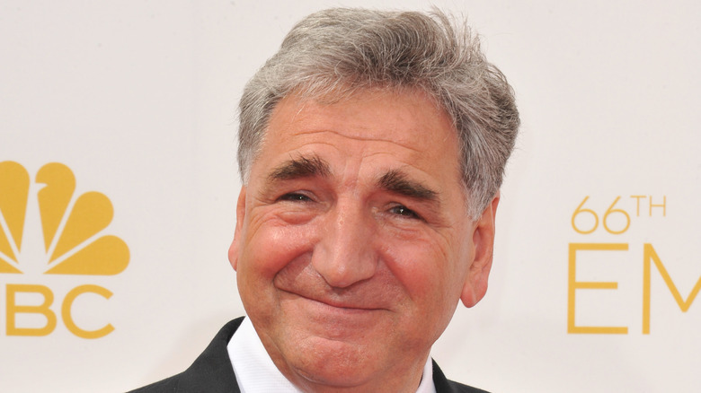 Jim Carter smirking in a tuxedo