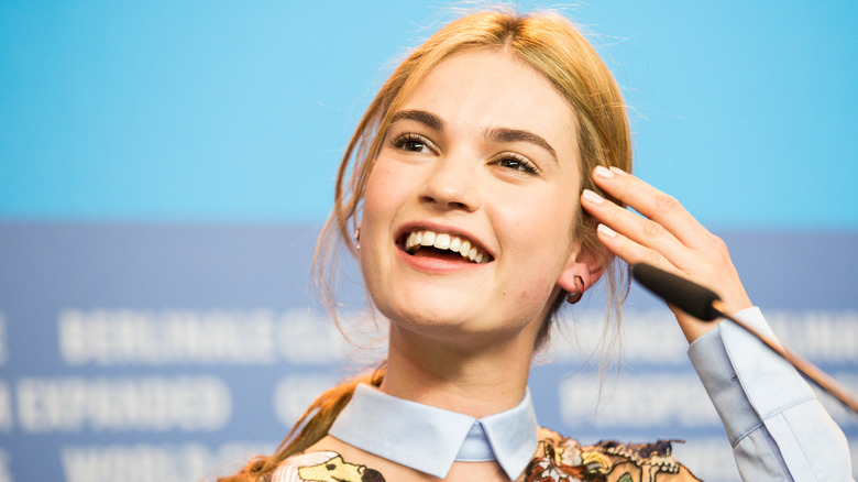 Lily James laughing, looking to side