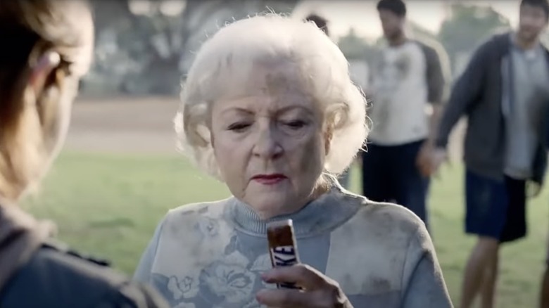 Betty White holding a Snickers bar