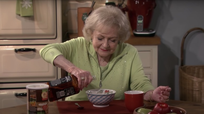 Betty White pouring a drink on Hot in Cleveland