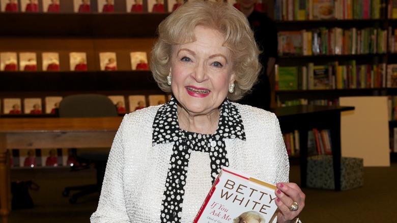 Betty White smiling with her book