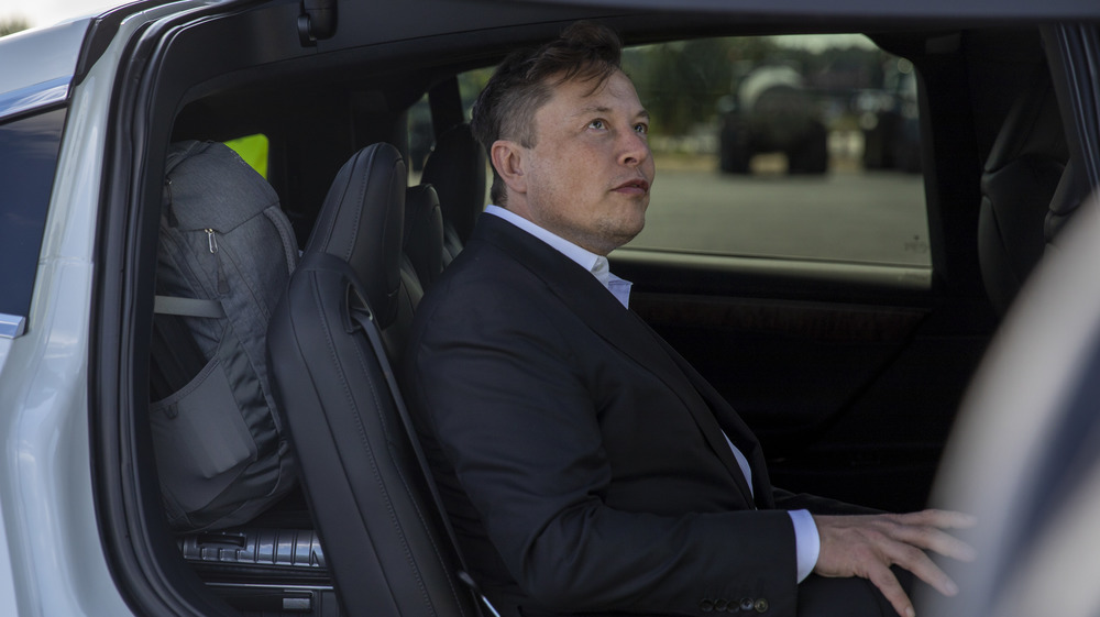 Elon Musk sitting in car