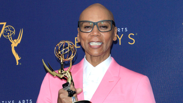 RuPaul posing with an Emmy