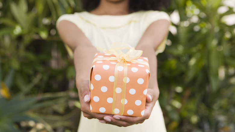 Woman holds gift with bow