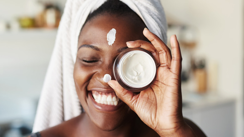 woman holding moisturizer